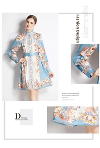 Detail of floral print dress featuring stand collar, long sleeves, and buckled waist belt