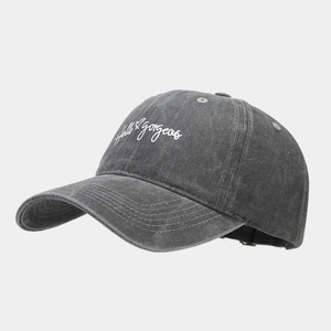 Detail of Hello Gorgeous white embroidery on dark grey washed cotton baseball cap texture