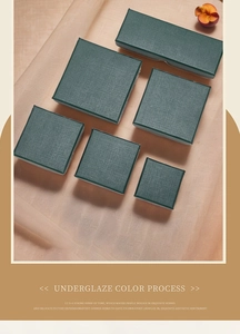 Elegant deep green textured jewelry boxes in various sizes on beige fabric display