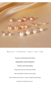Macro shot of natural freshwater pearl earrings in white and pink on gold silk fabric