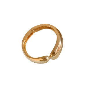 Elegant gold-tone irregular waterdrop open bangle with organic polished metallic finish