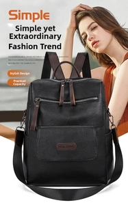 Close-up of black pebble grain leather backpack with brown handles and silver zippers