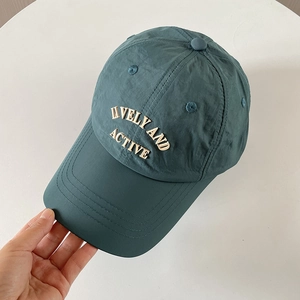 Close-up of a teal nylon quick-dry baseball cap with Lively and Active embroidery