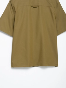 Back view of olive green short sleeve cargo shirt showing back yoke and hanging loop detail