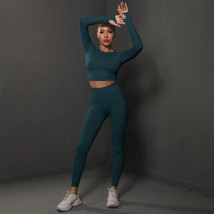 Detail view of teal high-waisted seamless yoga set with thumbhole sleeves for fitness