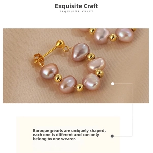 Detailed macro view of iridescent pink baroque pearls with gold bead accents