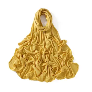 Detail of ginger yellow modal jersey scarf showing soft fabric texture and fine hemmed edges