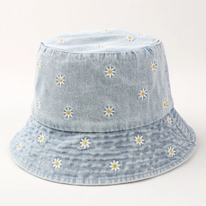 Faded blue denim bucket hat with white daisy embroidery and a classic round crown