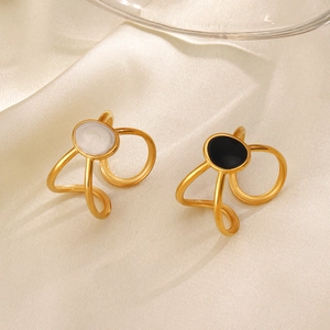 18K gold-plated oval enamel rings in black and white on elegant white silk fabric