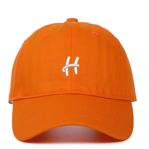 Close-up of premium orange twill cotton baseball cap with white embroidered H letter