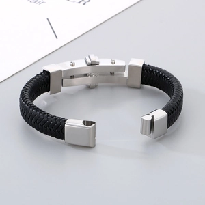 Detail of men's black braided leather bracelet with silver stainless steel clasp