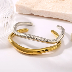 Snake pattern C-shape stainless steel gold bracelet on stone background display