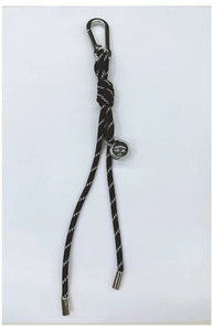 Detail of black woven rope keychain featuring silver metal ball and carabiner clasp