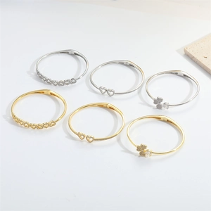 Golden and silver adjustable bangles with clover and heart zircon stone accents