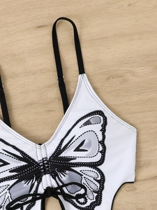 Detail of white bikini top with black butterfly print and adjustable thin straps