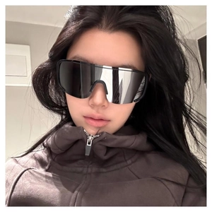 Close-up of black Y2K sports sunglasses with silver mirrored lenses on model