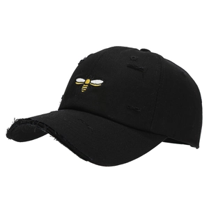 Distressed black cotton baseball cap with yellow bee embroidery and vintage torn design