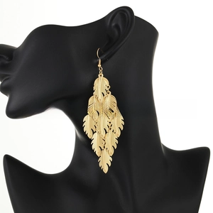 Detail of multi-layered gold leaf tassel earrings on model with elegant 18k gold plating