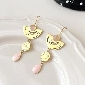 Gold-tone geometric drop earrings with pink crystals and enamel on ceramic tray