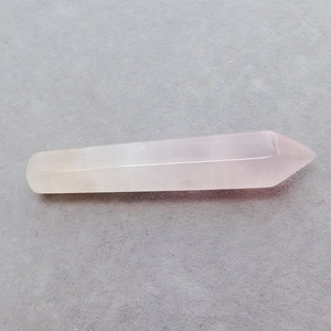 Detailed macro view of natural rose quartz hexagonal point crystal with smooth finish