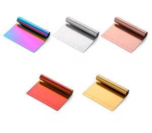 Detail of stainless steel dough scrapers in five colors with laser-etched scale
