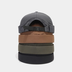Close-up of quick-dry skullcap stacks showing adjustable buckle and fabric texture