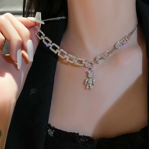 Detailed close-up of a silver-toned bear pendant necklace adorned with sparkling cubic zirconia