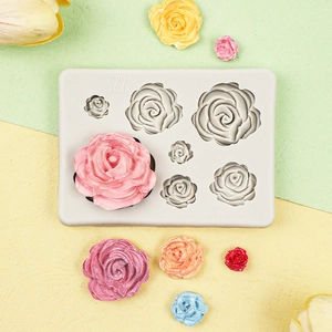 Detail of 3D rose silicone mold showing various sizes of finished floral cake decorations