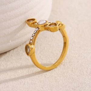 Detail of 18K gold plated cross ring with white pearls and sparkling rhinestones