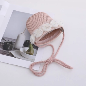 Detail of pink straw crossbody bag with cream mesh roses and colorful center beads