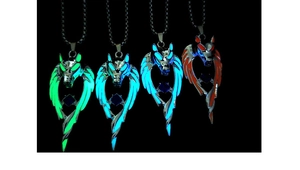 Close-up of four luminous wolf head wing pendants glowing in green, blue, and orange