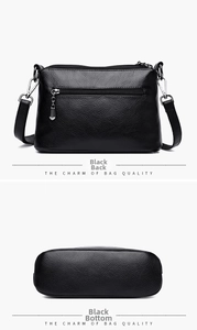 Detail view of the black PU leather handbag showing the back zipper and bottom structure