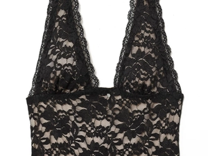 Detail of black lace dress showing deep V-neckline with delicate floral scallop edges