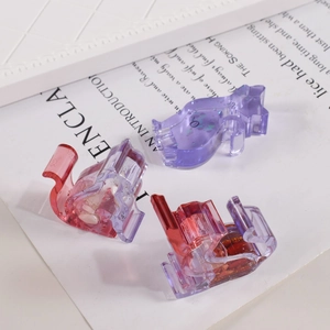 Detailed view of colorful resin cat charms with glitter inside for DIY craft jewelry making