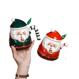 Green and red Santa Claus ceramic mugs with Christmas tree spoons and matching lids