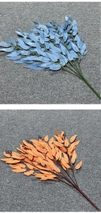 Detailed close-up of blue and orange artificial willow leaves with silk texture