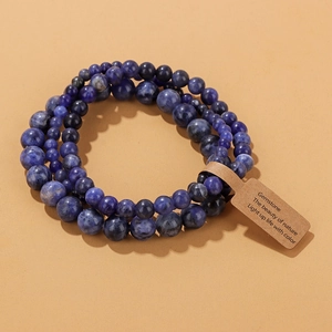 Three-piece set of blue sodalite gemstone bead bracelets with minimalist hanging tag