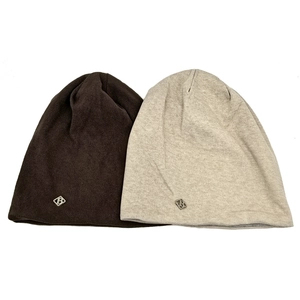 Close-up of knit texture and silver metal B logo tag on brown and gray beanies