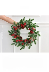 Close-up of Christmas wreath with PE pine needles, red berries, and white pine cones