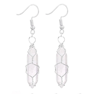 Detail of clear quartz hexagonal crystal pendant earrings with silver wire wrapping