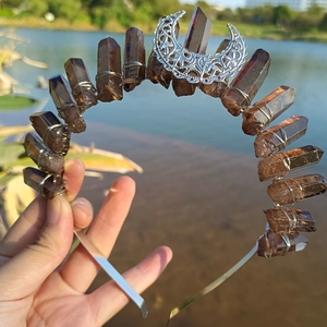 Detail of handmade silver crescent moon crown with natural brown crystal points