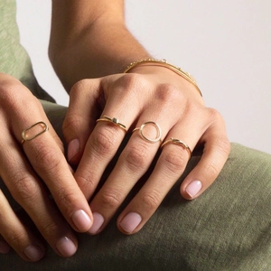 Set of gold minimalist hollow geometric stainless steel rings and bracelet on model hand
