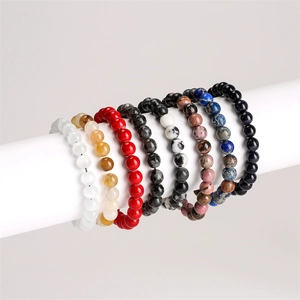 Detailed display of colorful natural stone beaded bracelets on white cylindrical stands