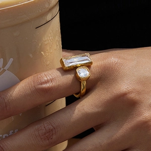 Golden stainless steel double stone ring with hammered texture worn on finger