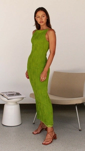 Detail of slim-fit neon green dress featuring unique textured ripple pleated fabric