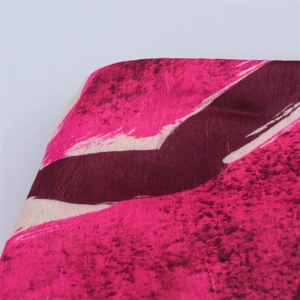 Close-up of pink and purple abstract print fabric texture with velvet fiber detail