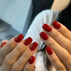 Glossy deep red almond nails for women featuring a high-shine mirror finish and square shape