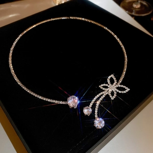 Detailed view of silver butterfly choker with zircon flowers and tassels in a gift box