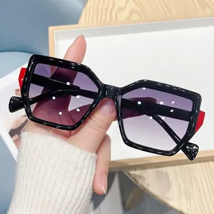 Polygonal oversized sunglasses with black-red frames and purple gradient lenses