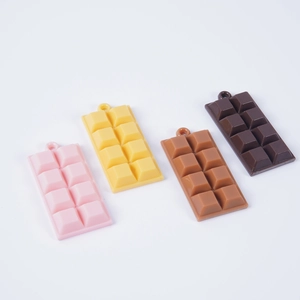 Set of four colorful realistic chocolate bar pendants in pink yellow and brown resin